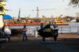 People stroll New Orleans riverfront against river traffic. New Orleans, LA.