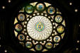 Stained glass window with early US states seals surrounding that of Massachusetts in State House. Boston, MA.