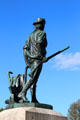 Minute Man statue of colonial farmer with plow, musket & powder horn at Old North Bridge. Concord, MA.