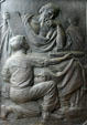 Relief of boy with torpedo & bearded man with math scroll on doors of Naval Academy Chapel. Annapolis, MD.