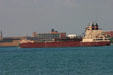 Great Lakes freighter American Courage passes Detroit Free Press building on Detroit River. MI.
