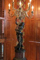 Sconce of woman holding chandelier in dining room at Campbell House Museum. St. Louis, MO.