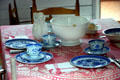 Table with China in Mark Twain birthplace cabin at Mark Twain Memorial Shrine. MO.