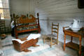 Bed, cradle, ladder-back chair & wash stand in Mark Twain birthplace cabin at Mark Twain Memorial Shrine. MO.