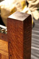 Subtle shaping of leg on Arts & Crafts settle at Stickley Museum at Craftsman Farms. Morris Plains, NJ.