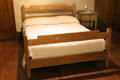 Oak double bed with inlay by Craftsman Workshops of Eastwood, NY at Gustav Stickley Museum at Craftsman Farms. Morris Plains, NJ.