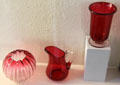 Ruby colored glass bowl, pitcher, spooner by Emil Stanger for Whitall Tatum Co. of Millville, NJ at Museum of American Glass. Milville, NJ.