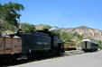 Virginia & Truckee steam locomotive #29 & tender amid passenger cars. Virginia City, NV.