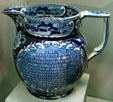 Blue transferware pitcher from Staffordshire, England showing Erie Canal scenes & eulogy to DeWitt Clinton in Buffalo History Museum. Buffalo, NY.