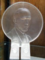Glass medalion of Frederick Carder design director of Corning Glass Works, founder of Steuben Glass & inventor of iridescent Aurene glass at Corning Museum of Glass. Corning, NY.