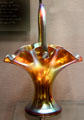 Gold Aurene glass basket with handle by Frederick Carder for Steuben Glass at Corning Museum of Glass. Corning, NY.
