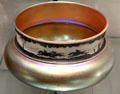 Aurene bowl with acid-etched rim shows horse race signed by Frederick Carder of Steuben Glass at Corning Museum of Glass. Corning, NY.