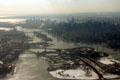 Manhattan skyline beside East River with arched rail Hell's Gate, Triborough Suspension & Queensboro Bridges from air. New York, NY.