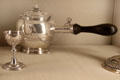 Silver teapot by I.C. French of Paris beyond French egg cup at Metropolitan Museum of Art. New York, NY.