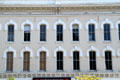 Heritage Italianate block with horseshoe window surrounds. Elyria, OH.