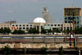 Camden City Hall with clocktower by Edwards & Green looms over white dome of New Jersey State Aquarium & One Port Center with yellow upper story. Camden, PA.
