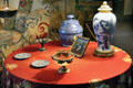 Round side table with ceramic antiques in dining room at Rough Point. Newport, RI.