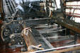 Hetherington Spinning Mule in expanded position where child labor once worked under mechanism fetching broken threads. Pawtucket, RI