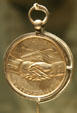 Peace & Friendship side of Jefferson Peace Medal given to natives by early American explorers at South Dakota State Historical Society Museum. Pierre, SD.