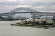 Texas State Aquarium beside bridge over bay with refineries in distance. Corpus Christi, TX.