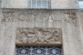 Limestone relief of two men taming horses like government over entrance door of Houston City Hall. Houston, TX.