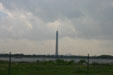 San Jacinto monument beside Texas ship channel with petroleum refinery beyond. Houston, TX.