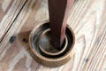 Ceramic water trap against insects under kitchen table leg at Nichols-Rice-Cherry House at Sam Houston Park. Houston, TX.