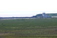 Whooping cranes in distance as tanker passes by at Aransas National Wildlife Refuge. TX.