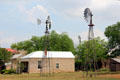 Fassel-Roeder House beyond windmills at Pioneer Museum. Fredericksburg, TX.