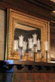 Candle holders with glass chimneys on dining room Arts & Crafts mantelpiece at McFaddin-Ward House. Beaumont, TX.