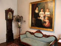 Entry hall with tall clock, settee & historic painting at McCulloch House. Waco, TX