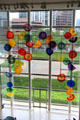 Glass composition by Dale Chihuly with view of city beyond at Dallas Museum of Art. Dallas, TX.