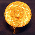 Greek gold medallion with head of Dionysos at Dallas Museum of Art. Dallas, TX.