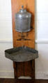 Water dispenser with drip pan in kitchen at French Legation Museum. Austin, TX.