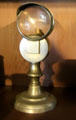 Candlestick with magnifying lens to concentrate light at Shelburne Museum. Shelburne, VT.