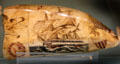 Scrimshaw whale tooth with engraved tall ship at Shelburne Museum. Shelburne, VT.