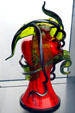 Red & green leafy glass sculpture by Dale Chihuly in Venetian Wall. Tacoma, WA.