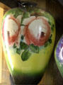 Milk glass vase with green to yellow color gradient & pink roses at Fostoria Glass Museum. Moundsville, WV.