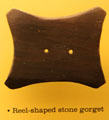 Reel-shaped stone gorget of early or middle Adena period at Grave Creek Mound Museum. Moundsville, WV.