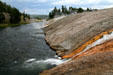 Waterfall from Excelsior Geyser flows into Firehole River at Yellowstone National Park. WY.