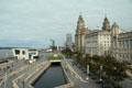 Ferry building, a canal extension , modern highrises & heritage Three Graces buildings on Liverpool's Mersey River waterfront. Liverpool, England