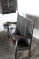 Simply furnished interior with bench of Nantwallter Cottage at St Fagans National Museum of History. Cardiff, Wales.