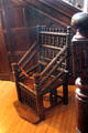 Vintage carved wood spooled arm chair with foot rest at St Fagans Castle. Cardiff, Wales