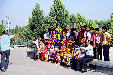 Visitors lined up for a photo in front of Registan mosque in Samarkand. Uzbekistan.