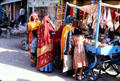 Women buying items from street vendor in Mandawa. Mandawa, India.